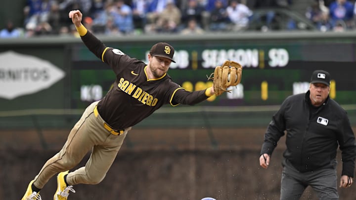 Apr 5, 2025; Chicago, Illinois, USA;  San Diego Padres second baseman Jake Cronenworth (9) can’t make the play as Chicago Cubs second baseman Nico Hoerner (2)  steals second base during the sixth inning at Wrigley Field. Mandatory Credit: Matt Marton-Imagn Images