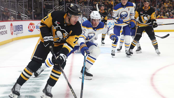 Nov 26, 2025; Pittsburgh, Pennsylvania, USA; Pittsburgh Penguins center Evgeni Malkin (71) moves the puck as Buffalo Sabres defenseman Owen Power (25) chases during the third period at PPG Paints Arena. Mandatory Credit: Charles LeClaire-Imagn Images