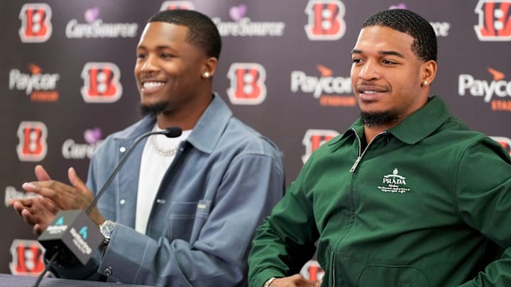 Cincinnati Bengals receivers Tee Higgins (left) and Ja’marr Chase take the stage during a press conference to announce the signing of new contracts for the pair at Paycor Stadium in downtown Cincinnati on Tuesday, March 18, 2025. Chase becomes the new highest-paid non-quarterback player in the NFL.