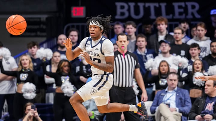 Butler Bulldogs guard Azavier Robinson (23) jumps over Georgetown Hoyas guard KJ Lewis (5) to pass Saturday, Jan. 31, 2026, during a basketball game between the Butler Bulldogs and the Georgetown Hoyas at Hinkle Fieldhouse in Indianapolis.