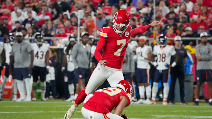 Aug 22, 2024; Kansas City, Missouri, USA; Kansas City Chiefs kicker Harrison Butker (7) kicks a point after touchdown against the Chicago Bears during the first half at GEHA Field at Arrowhead Stadium. Mandatory Credit: Denny Medley-Imagn Images