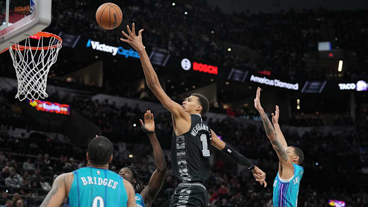 Jan 12, 2024; San Antonio, Texas, USA;  San Antonio Spurs center Victor Wembanyama (1) shoots over Charlotte Hornets forwards JT Thor (21) and forward Miles Bridges (0) in the second half at Frost Bank Center. Mandatory Credit: Daniel Dunn-Imagn Images