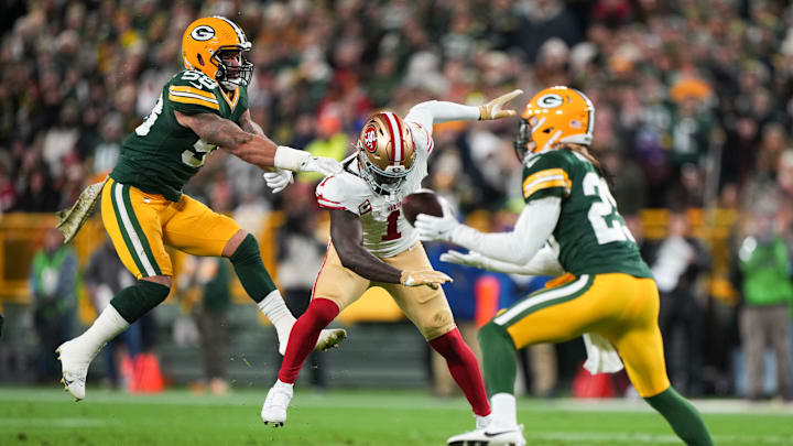 San Francisco 49ers wide receiver Deebo Samuel (C) loses a ball to Green Bay Packers safety Xavier McKinney (R)