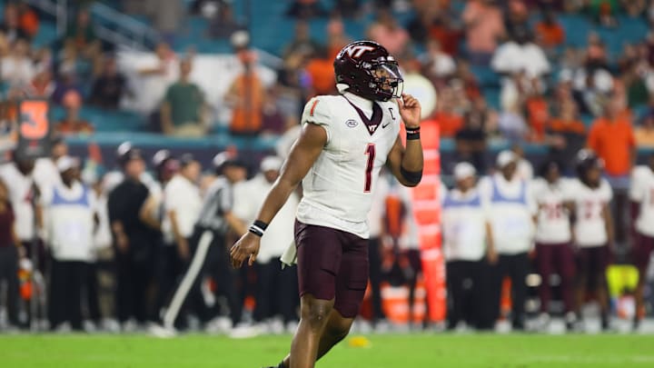 Sep 27, 2024; Miami Gardens, Florida, USA; Virginia Tech Hokies quarterback Kyron Drones (1) reacts from the field against the Miami Hurricanes during the third quarter at Hard Rock Stadium. Mandatory Credit: Sam Navarro-Imagn Images Sep 27, 2024; Miami Gardens, Florida, USA; Virginia Tech Hokies quarterback Kyron Drones (1) reacts from the field against the Miami Hurricanes during the third quarter at Hard Rock Stadium. Mandatory Credit: Sam Navarro-Imagn Images
