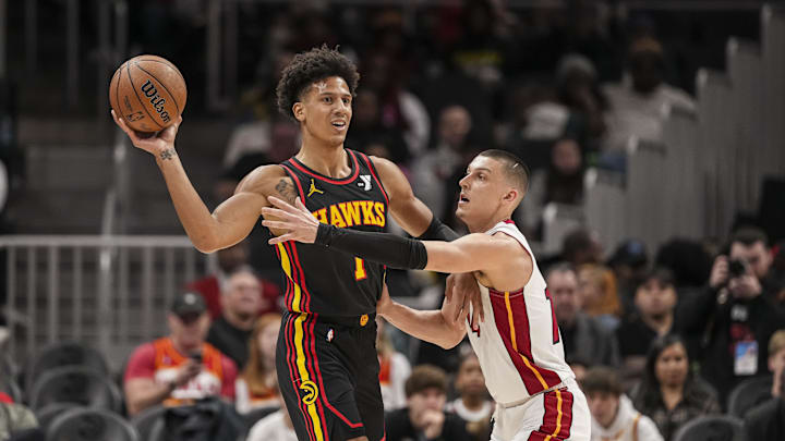 Dec 28, 2024; Atlanta, Georgia, USA; Atlanta Hawks forward Jalen Johnson (1) protects the ball from Miami Heat guard Tyler Herro (14) during the first half at State Farm Arena. Mandatory Credit: Dale Zanine-Imagn Images