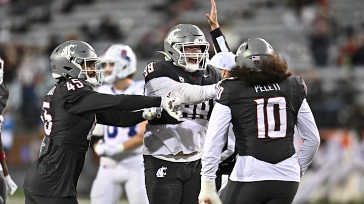 Nov 15, 2025; Pullman, Washington, USA; Washington State Cougars defensive lineman Buddha Peleti (10) celebrates after a play with his teammate against the Louisiana Tech Bulldogs in the second half at Gesa Field at Martin Stadium. Mandatory Credit: James Snook-Imagn Images
