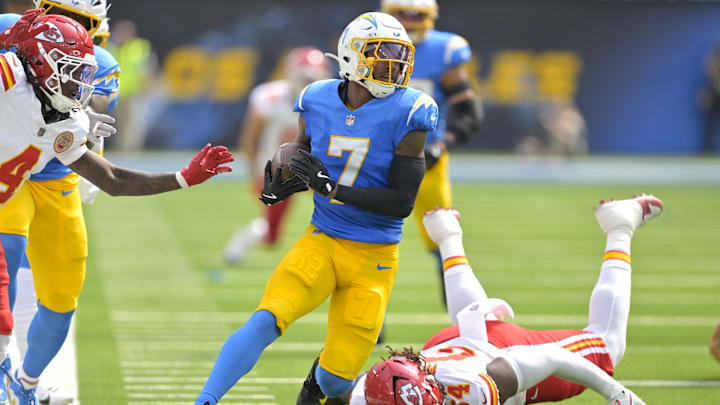 Sep 29, 2024; Inglewood, California, USA;  Los Angeles Chargers cornerback Kristian Fulton (7) avoids a tackle by Kansas City Chiefs offensive tackle Wanya Morris (64) after an interception in the first half at SoFi Stadium. Mandatory Credit: Jayne Kamin-Oncea-Imagn Images