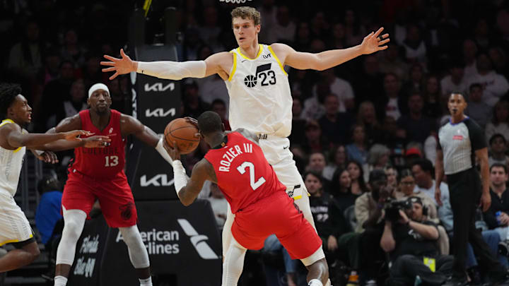 Jan 4, 2025; Miami, Florida, USA;  Utah Jazz forward Lauri Markkanen (23) defends Miami Heat guard Terry Rozier (2) during the first half at Kaseya Center. Mandatory Credit: Jim Rassol-Imagn Images