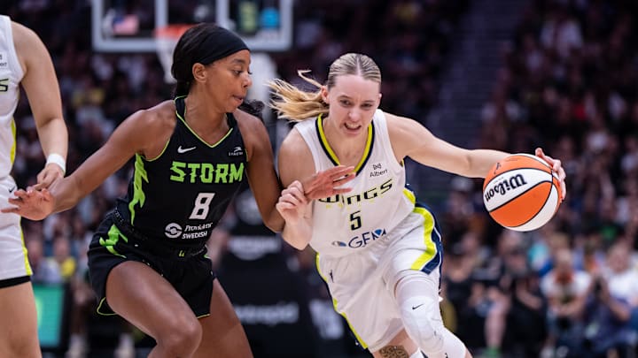 Dallas Wings guard Paige Bueckers dribbles the ball against Seattle Storm guard Lexie Brown.