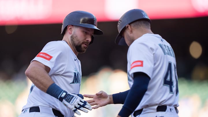 Seattle Mariners catcher Cal Raleigh (29), left, is congratulatd by third base coach Kristopher Negron after hitting a solo home run during the first inning at T-Mobile Park on May 27.