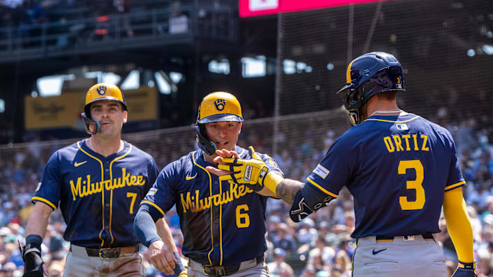Jul 23, 2025; Seattle, Washington, USA;  Milwaukee Brewers left fielder Isaac Collins (6) and first baseman Tyler Black (7) are congratulated by shortstop Joey Ortiz (3) after scoring runs during the second inning against the Seattle Mariners at T-Mobile Park. Mandatory Credit: Stephen Brashear-Imagn Images