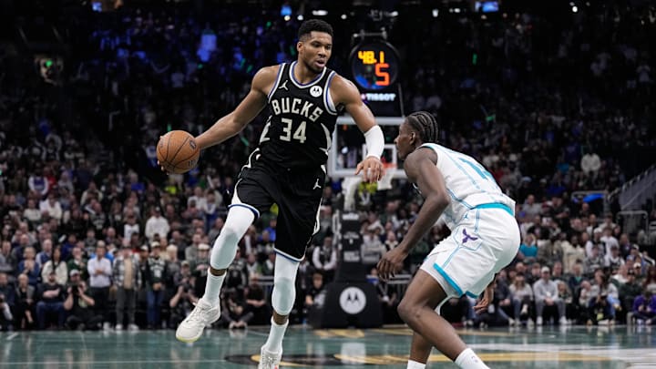 Nov 14, 2025; Milwaukee, Wisconsin, USA;  Milwaukee Bucks forward Giannis Antetokounmpo (34) dribbles the ball as Charlotte Hornets forward Moussa Diabate (14) defends during overtime at Fiserv Forum. Mandatory Credit: Jeff Hanisch-Imagn Images