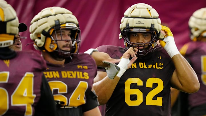 Arizona State offensive linemen Wade Helton (64) and Ben Coleman (62) run a drill during a practice inside the Verde Dickey Dome in Tempe on August 12, 2025.