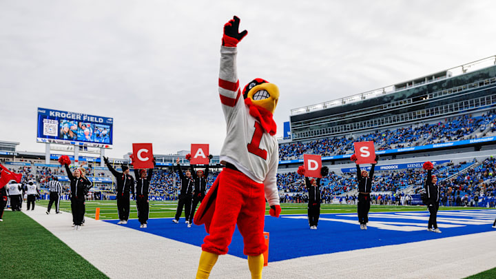 Nov 30, 2024; Lexington, Kentucky, USA; The Louisville Cardinals mascot performs with cheerleaders after a touchdown during the third quarter against the Kentucky Wildcats at Kroger Field. Mandatory Credit: Jordan Prather-Imagn Images