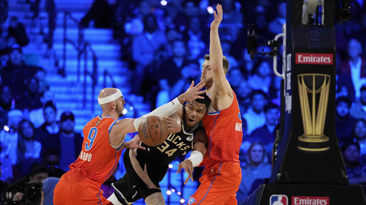 Dec 17, 2024; Las Vegas, Nevada, USA; Milwaukee Bucks forward Giannis Antetokounmpo (34) passes against Oklahoma City Thunder center Isaiah Hartenstein (55) and guard Alex Caruso (9) during the 1st quarter of the Emirates NBA Cup championship game at T-Mobile Arena. Mandatory Credit: Kyle Terada-Imagn Images Dec 17, 2024; Las Vegas, Nevada, USA; Milwaukee Bucks forward Giannis Antetokounmpo (34) passes against Oklahoma City Thunder center Isaiah Hartenstein (55) and guard Alex Caruso (9) during the 1st quarter of the Emirates NBA Cup championship game at T-Mobile Arena. Mandatory Credit: Kyle Terada-Imagn Images