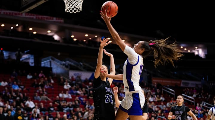 Johnston's Jenica Lewis (10) drives to the basket against Iowa City Liberty's Madilyn Meyer (24) on Monday, March 3, 2025, at Wells Fargo Arena.