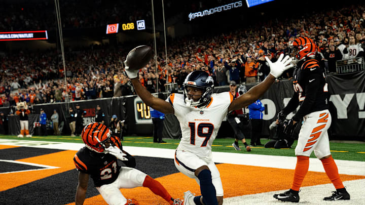 Denver Broncos wide receiver Marvin Mims Jr. (19) reacts to scoring a touchdown as Cincinnati Bengals cornerback Mike Hilton (21) and Cincinnati Bengals safety Geno Stone (22) look on with 8 seconds left in the fourth quarter of the NFL game at Paycor Stadium in Cincinnati on Saturday, Dec. 28, 2024.