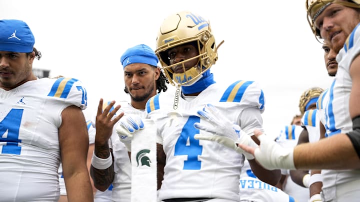 Oct 11, 2025; East Lansing, Michigan, USA; UCLA defensive back Key Lawrence (4) holds a towel with the Michigan State logo after defeating the Spartans at Spartan Stadium. Mandatory Credit: Brendan Mullin-Imagn Images