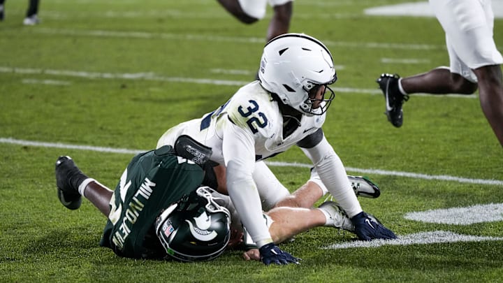 Nov 15, 2025; East Lansing, Michigan, USA; Penn State linebacker Keon Wylie (32) tackles Michigan State quarterback Alessio Milivojevic (11) as the ball is thrown at Spartan Stadium. Mandatory Credit: Brendan Mullin-Imagn Images