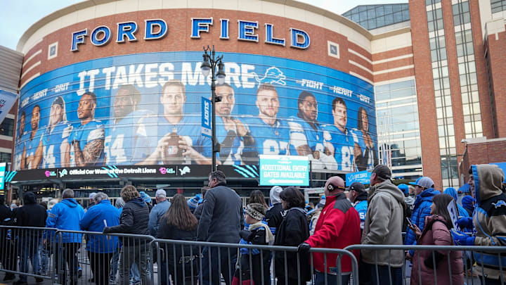Football fans line up outside of Gate A of Ford Field.