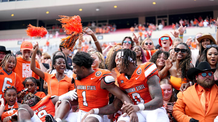 Oklahoma State players celebrate with fans following the second half of the college football game between the Oklahoma State Cowboys and South Dakota State Jackrabbits at Boone Pickens Stadium in Stillwater, Okla., Saturday, Aug., 31, 2024. Oklahoma State players celebrate with fans following the second half of the college football game between the Oklahoma State Cowboys and South Dakota State Jackrabbits at Boone Pickens Stadium in Stillwater, Okla., Saturday, Aug., 31, 2024.