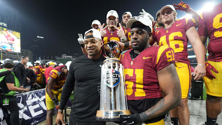 Dec 27, 2023; San Diego, CA, USA; Southern California Trojans director of player development Chris Carter (left) and defensive end Solomon Byrd (51) hold the Holiday Bowl championship trophy at Petco Park. Mandatory Credit: Kirby Lee-Imagn Images Dec 27, 2023; San Diego, CA, USA; Southern California Trojans director of player development Chris Carter (left) and defensive end Solomon Byrd (51) hold the Holiday Bowl championship trophy at Petco Park. Mandatory Credit: Kirby Lee-Imagn Images