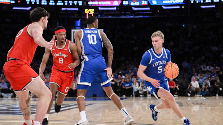 Dec 21, 2024; New York, New York, USA; Kentucky Wildcats guard Collin Chandler (5) sets the play while being defended by Ohio State Buckeyes guard Micah Parrish (8) and center Austin Parks (25) during the first half at Madison Square Garden. Mandatory Credit: John Jones-Imagn Images