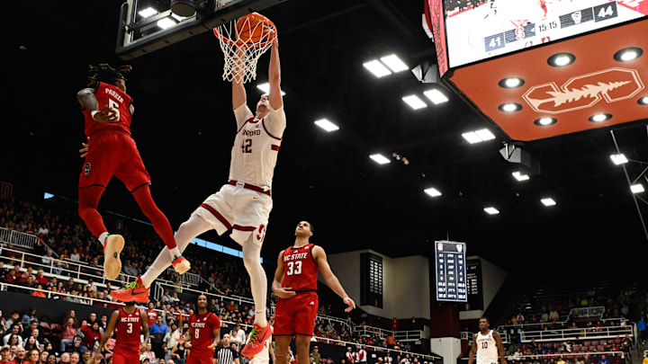 Feb 8, 2025; Stanford, California, USA; Stanford Cardinal forward Maxime Raynaud (42) dunks against NC State Wolfpack guard Trey Parker (5) in the second half at Maples Pavilion. Mandatory Credit: Eakin Howard-Imagn Images