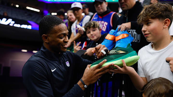 Jan 3, 2025; Sacramento, California, USA; Sacramento Kings guard De'Aaron Fox (5) signs autographs for fans before the game against the Memphis Grizzlies at Golden 1 Center. Mandatory Credit: Sergio Estrada-Imagn Images