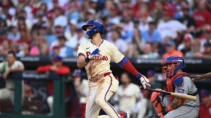 Oct 6, 2024; Philadelphia, Pennsylvania, USA; Philadelphia Phillies shortstop Trea Turner (7) hits a single in the sixth inning against the New York Mets during game two of the NLDS for the 2024 MLB Playoffs at Citizens Bank Park. 