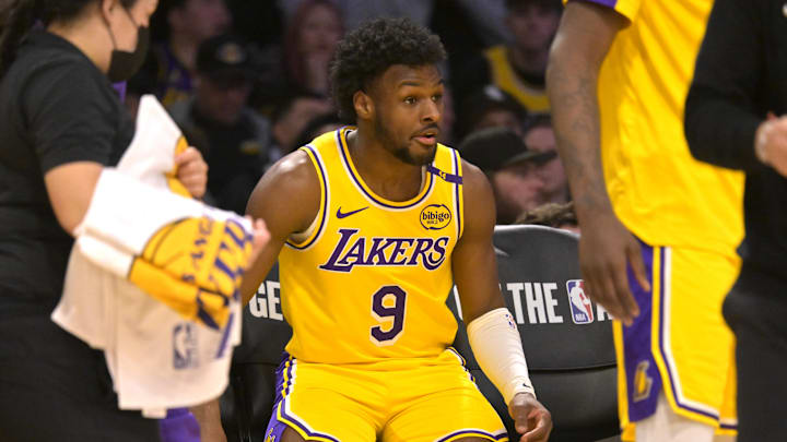 Mar 19, 2025; Los Angeles, California, USA;  Los Angeles Lakers guard Bronny James (9) sits on the bench during a time out in the second half against the Denver Nuggets at Crypto.com Arena. Mandatory Credit: Jayne Kamin-Oncea-Imagn Images