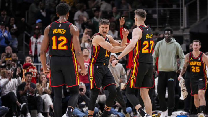 Mar 28, 2024; Atlanta, Georgia, USA; Atlanta Hawks guard Bogdan Bogdanovic (13) reacts with guard