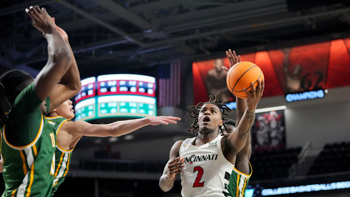 Cincinnati Bearcats guard Jizzle James (2) rises to the basket in the first half of a college