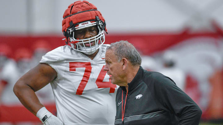 Arkansas Razorbacks coach Sam Pittman with offensive lineman Marcus Dumerville during a spring practice at the indoor center in Fayetteville, Ark.