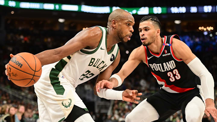 Jan 4, 2025; Milwaukee, Wisconsin, USA; Milwaukee Bucks forward Khris Middleton (22) drives for the basket against Portland Trail Blazers forward Toumani Camara (33) in the third quarter at Fiserv Forum. Mandatory Credit: Benny Sieu-Imagn Images