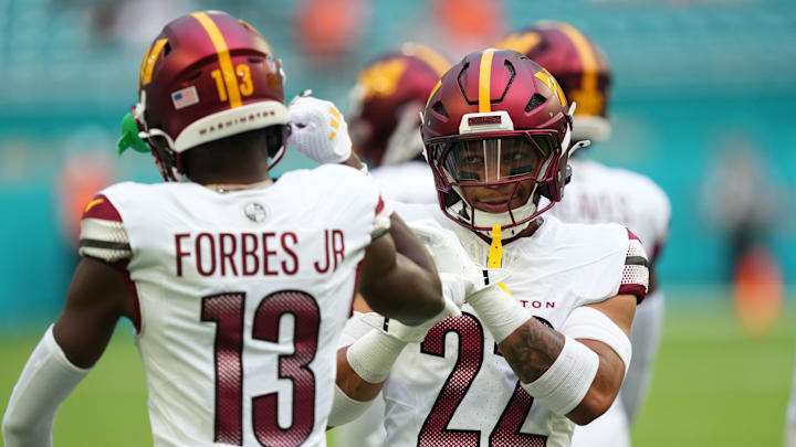 Aug 17, 2024; Miami Gardens, Florida, USA;  Washington Commanders cornerback Emmanuel Forbes Jr. (13) and safety Darrick Forrest (22) warm up before the game against the against the Miami Dolphins at Hard Rock Stadium. Mandatory Credit: Jim Rassol-Imagn Images