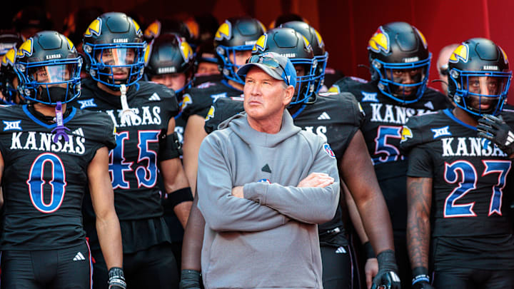 Nov 9, 2024; Kansas City, Missouri, USA; Kansas Jayhawks coach Lance Leipold leads the team onto the field for the game against the Iowa State Cyclones at GEHA Field at Arrowhead Stadium. Mandatory Credit: William Purnell-Imagn Images