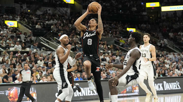 Apr 14, 2024; San Antonio, Texas, USA; Detroit Pistons guard Jared Rhoden (8) drives to the basket between San Antonio Spurs guards Davonte' Graham (4) and Sidy Cissoko (25) during the first half at Frost Bank Center. Mandatory Credit: Scott Wachter-Imagn Images