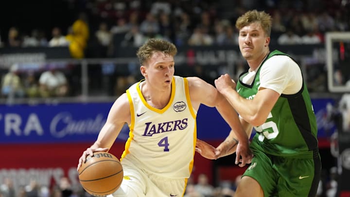 Jul 15, 2024; Las Vegas, NV, USA; Los Angeles Lakers forward Dalton Knecht (4) drives the ball against Boston Celtics guard Baylor Scheierman (55) during the first half at Thomas & Mack Center. Mandatory Credit: Lucas Peltier-Imagn Images