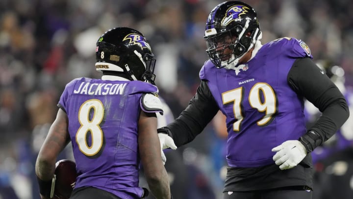 Baltimore Ravens quarterback Lamar Jackson (8) celebrates with offensive tackle Ronnie Stanley (79) after scoring a touchdown against the Houston Texans during the third quarter of a 2024 AFC divisional round game at M&T Bank Stadium. 