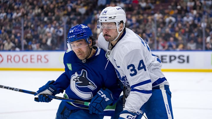 Feb 8, 2025; Vancouver, British Columbia, CAN; Vancouver Canucks forward Kiefer Sherwood (44) checks Toronto Maple Leafs forward Auston Matthews (34) in the second period at Rogers Arena. Mandatory Credit: Bob Frid-Imagn Images