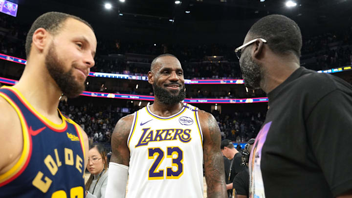 Jan 25, 2025; San Francisco, California, USA; Los Angeles Lakers forward LeBron James (23) talks with Golden State Warriors guard Stephen Curry (30) and forward Draymond Green (right) after the game at Chase Center. Mandatory Credit: Darren Yamashita-Imagn Images