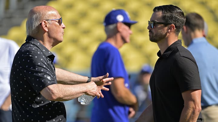 Jul 19, 2024; Los Angeles, California, USA;  Los Angeles Dodgers President and CEO Stan Kasten talks with Executive Vice President and General Manager Brandon Gomes on the field prior to the game between the Los Angeles Dodgers and the Boston Red Sox at Dodger Stadium. Mandatory Credit: Jayne Kamin-Oncea-Imagn Images
