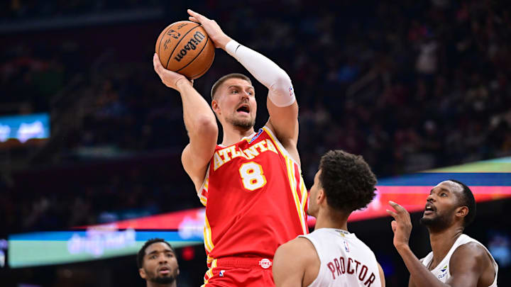 Nov 2, 2025; Cleveland, Ohio, USA; Atlanta Hawks forward Kristaps Porzingis (8) drives to the basket against Cleveland Cavaliers guard Tyrese Proctor (24) during the first half at Rocket Arena. Mandatory Credit: Ken Blaze-Imagn Images