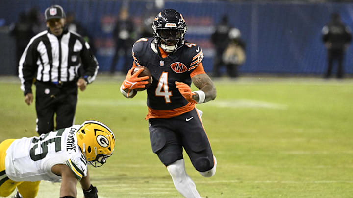 Jan 10, 2026; Chicago, IL, USA;  Chicago Bears running back D'Andre Swift (4) runs runs after the catch as Green Bay Packers defensive end Kingsley Enagbare (55) defends during the second half of an NFC Wild Card Round game at Soldier Field. Mandatory Credit: Matt Marton-Imagn Images
