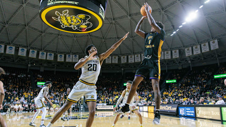 Jan 24, 2024; Wichita, Kansas, USA; East Carolina Pirates forward Brandon Johnson (6) puts up a shot over Wichita State Shockers guard Harlond Beverly (20) during the second half at Charles Koch Arena. Mandatory Credit: William Purnell-Imagn Images