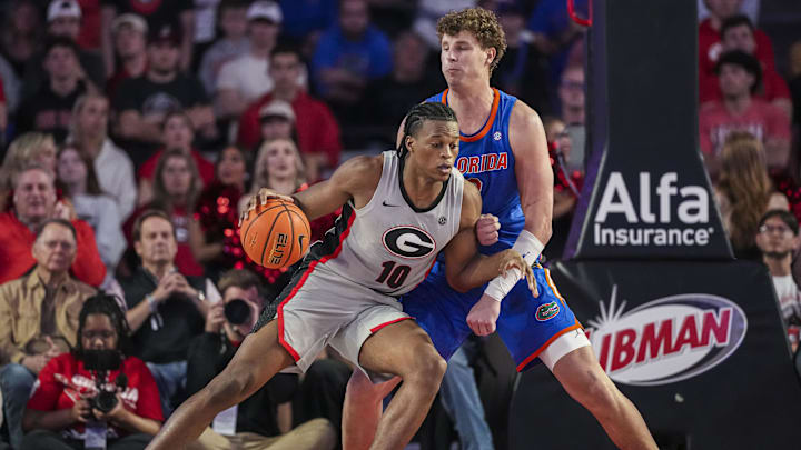 Feb 25, 2025; Athens, Georgia, USA; Georgia Bulldogs forward RJ Godfrey (10) dribbles against Florida Gators center Micah Handlogten (3) during the second half at Stegeman Coliseum. Mandatory Credit: Dale Zanine-Imagn Images