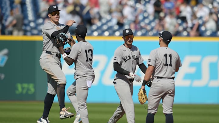 Apr 23, 2025; Cleveland, Ohio, USA; New York Yankees right fielder Aaron Judge (99) and second baseman Jazz Chisholm Jr. (13) and center fielder Cody Bellinger (35) and shortstop Anthony Volpe (11) celebrate after the Yankees beat the Cleveland Guardians at Progressive Field. Mandatory Credit: Ken Blaze-Imagn Images