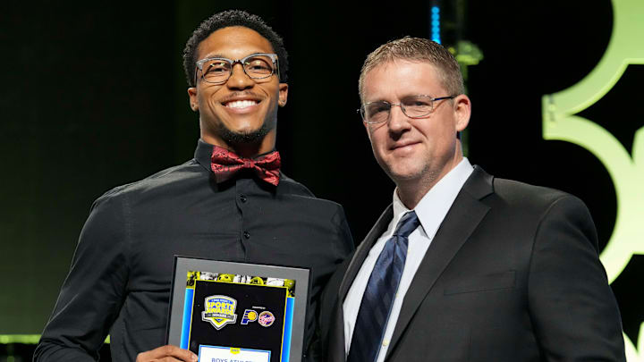 Fishers’ JonAnthony Hall (left) poses with IndyStar sports reporter Kyle Neddenriep after Hall is awarded Boy’s Athlete of the Year during the Indiana High School Sports Awards on Sunday, April 27, 2025, at Clowes Memorial Hall in Indianapolis.