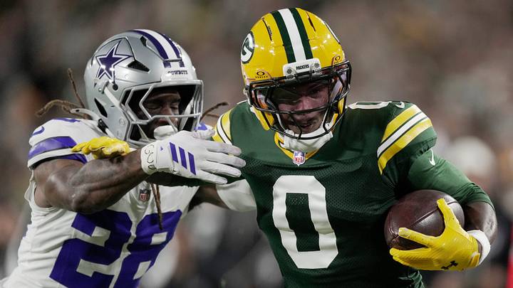 Green Bay Packers wide receiver Matthew Golden (0) is tackled by Dallas Cowboys' Shavon Revel Jr. (28) on a 37-yard reception during the first quarter of their game Sunday, Oct. 18, 2026 at Lambeau Field in Green Bay, Wisconsin.